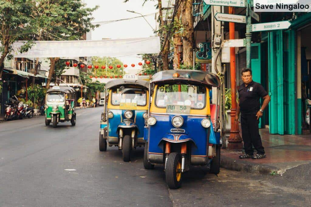 Man Standing Beside Parked Trikes